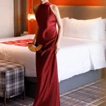 Front view of a red long qipao dress, a sleeveless Chinese wedding qipao dress made of lustrous satin, perfect for bridal photoshoots and wedding ceremonies.