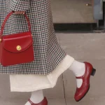 Close-up of red Margarita 1920s vintage schoolgirl leather Qipao shoes paired with a retro red leather handbag, highlighting the classic cheongsam footwear’s elegant silhouette.