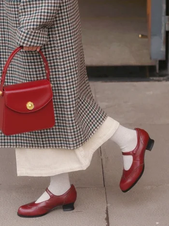 Close-up of red Margarita 1920s vintage schoolgirl leather Qipao shoes paired with a retro red leather handbag, highlighting the classic cheongsam footwear’s elegant silhouette.
