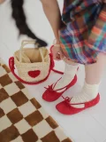 Bright red suede Mary Jane qipao shoes paired with white vintage lace socks and a woven straw bag, perfect for a sweet, everyday retro look