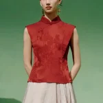 Full front view of a model wearing a red modern mandarin collar cheongsam top, a women's red chinese slim fit jacquard cheongsam top, showcasing the elegant tailored silhouette.