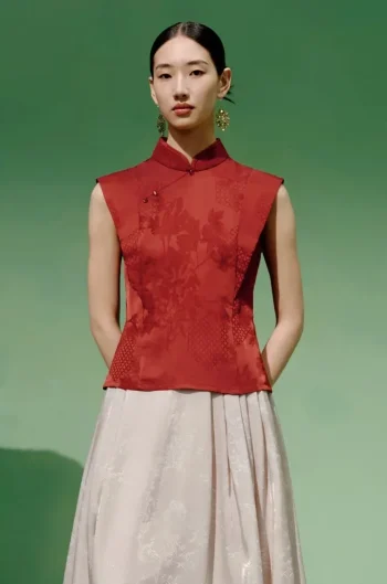 Full front view of a model wearing a red modern mandarin collar cheongsam top, a women's red chinese slim fit jacquard cheongsam top, showcasing the elegant tailored silhouette.