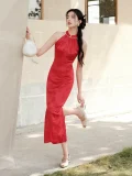 Dynamic outdoor shot of women's red mulberry silk halter neck midi qipao dress, featuring a sleek mermaid silhouette, side slit design, and elegant drape of the satin-like mulberry silk fabric for modern Chinese weddings