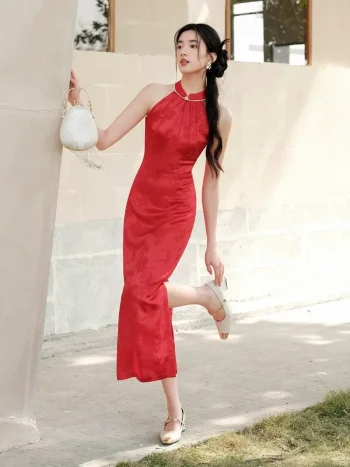 Dynamic outdoor shot of women's red mulberry silk halter neck midi qipao dress, featuring a sleek mermaid silhouette, side slit design, and elegant drape of the satin-like mulberry silk fabric for modern Chinese weddings