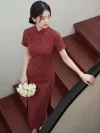 Women's 1940s traditional red plaid qipao, a classic red qipao dress with a refined checkered pattern, tailored fit, and vintage-inspired design. The model stands on a wooden staircase holding a bouquet of white roses, showcasing the flattering silhouette and elegant charm of this timeless traditional qipao.