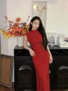Women's Modified Chinese Red Qipao Dress - Woman in red qipao dress leaning on a black cabinet with orange lantern flower decor, modern chinese dress qipao with 3D floral details