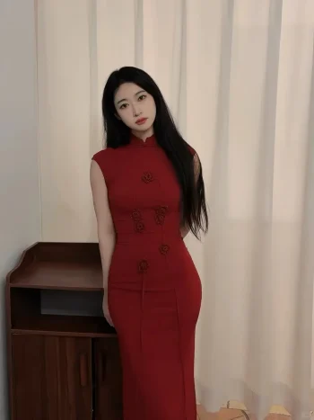 Women's Red Qipao Dress - Woman in modified chinese qipao dress standing in front of sheer white curtains, sleeveless form-fitting maxi red qipao dress for women