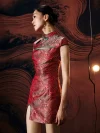 Side profile of model in a red modern short qipao dress, showcasing the tailored form-fitting silhouette, high side slit, and intricate wave brocade pattern accented with contrasting green trim.
