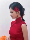 Red Silk Cheongsam - Close-up side view of bride in modern red silk cheongsam for wedding, showcasing mandarin collar, sleeveless design, and delicate frog buttons, paired with traditional red paper-cut hair accessories and double happiness earrings.