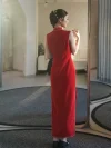 Modern Qipao Wedding Dress - Full back view of a red sleeveless long modified qipao, standing in front of a mirror in a sunlit trial room. The dress features clean lines, delicate trim along the side slit, and a refined back neckline, perfect for brides seeking a timeless yet modern wedding look.
