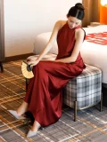 Close-up view of a red sleeveless qipao long dress, a modern Chinese wedding qipao dress with smooth satin fabric, perfect for bridal engagement and wedding events.