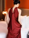 Back view of a red sleeveless qipao long dress, a stunning Chinese wedding qipao dress with an elegant back tie design, crafted in smooth satin fabric for bridal occasions.