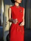 Red Modern Modified Sleeveless Long Wedding Qipao Dress - Close-up of the elegant mandarin collar and floral embroidery details on a sleeveless red qipao wedding dress. The bride holds a flower branch in soft backlit light, highlighting the delicate craftsmanship and refined design of this modern qipao for weddings.