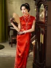 Woman in a traditional red wedding qipao standing by an antique grandfather clock, holding a fan, showing the elegant cheongsam design for weddings.
