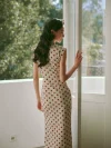 Back view of retro Hong Kong cotton qipao dress, woman in polka dot cap sleeve qipao touching door frame on balcony, daily vintage qipao style