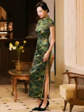 Side profile view of a woman in a retro shanghai qipao dress, form-fitting mulberry silk cheongsam with leaf print and high side slit, styled with black heels in a classic republican era interior.