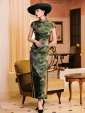 Full-body shot of a woman in a shanghai style retro qipao dress, mulberry silk cheongsam with leaf print and high slit, paired with a black wide-brim hat and heels in a vintage-style interior.