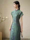 Side view of women's green modified qipao dress, short sleeve floral pattern cheongsam with 3D cut flower craft fabric, highlighting the elegant slim fit and smooth drape
