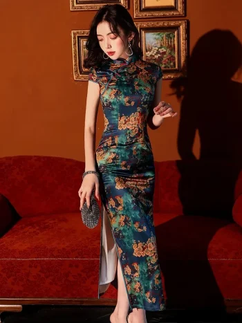 Close-up shot of model in a vintage floral pattern silk qipao dress, showing the vibrant print, smooth silk texture, and high slit detail with a crystal clutch in a warm-toned studio.