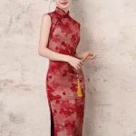 Smiling model wearing the women's chinese red floral pattern cheongsam, a red cheongsam dress with classic mandarin collar and vibrant red floral print. This sleeveless cheongsam dress exudes warm festive charm, ideal for bridal photoshoots, tea ceremonies, and special occasions.
