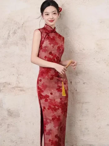 Smiling model wearing the women's chinese red floral pattern cheongsam, a red cheongsam dress with classic mandarin collar and vibrant red floral print. This sleeveless cheongsam dress exudes warm festive charm, ideal for bridal photoshoots, tea ceremonies, and special occasions.