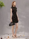 Model walking in a summer black base rose print sleeveless short qipao dress, highlighting the form-fitting cut, ruffled hem, and lightweight summer-ready fabric.