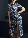 Three-quarter view of a woman posing in a blue crane print midi cheongsam dress, showcasing the form-fitting silhouette, traditional golden frog buttons, and detailed crane pattern of this modern blue cheongsam.