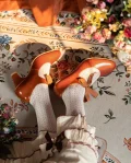 Top-down view of vintage genuine leather qipao shoes, brown ribbon mary jane heels worn with white lace socks and retro dress, highlighting the butterfly ribbon detail against a floral vintage rug backdrop