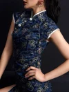 Upper body close-up of a woman wearing a modern fashion dark blue peacock short cheongsam dress, showcasing the silver frog buttons, mandarin collar, and luxurious peacock print details of this elegant dark blue cheongsam.