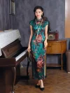 Full-length front view of women's vintage green silk qipao with peony print, model standing by piano in retro interior