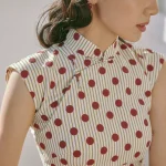 Close-up of vintage Hong Kong cotton qipao dress, red polka dot striped qipao with traditional frog buttons, cap sleeve qipao fabric detail