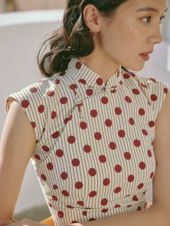 Close-up of vintage Hong Kong cotton qipao dress, red polka dot striped qipao with traditional frog buttons, cap sleeve qipao fabric detail