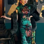 Woman in an Old Shanghai peony print cheongsam (19 Mome mulberry silk) paired with a black fur shawl, posing against a wall with vintage photos, exuding retro elegance.