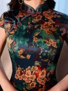 Close-up detail of a Chinese vintage floral silk qipao dress, focusing on the traditional frog closure, mandarin collar trim, and intricate floral pattern on premium silk fabric.