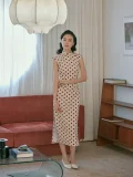 Model posing indoors in the "Waltz of Youth" cotton qipao dress, a midcentury-inspired cheongsam designed for daily wear with a flattering, form-fitting cut.
