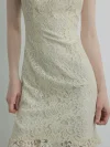 Detailed close-up of the floral lace fabric used for a white modern Chinese cheongsam dress, showcasing the intricate pattern, soft texture, and semi-sheer design.