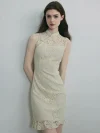 Full front view of a woman wearing a sleeveless white lace cheongsam dress, standing with hands behind her back to highlight the traditional mandarin collar with pearl buttons and modern bodycon fit.