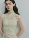 Close-up of the neckline of a white modern cheongsam dress, showing the delicate lace overlay, traditional frog closure with pearl accents, and the keyhole cutout design.