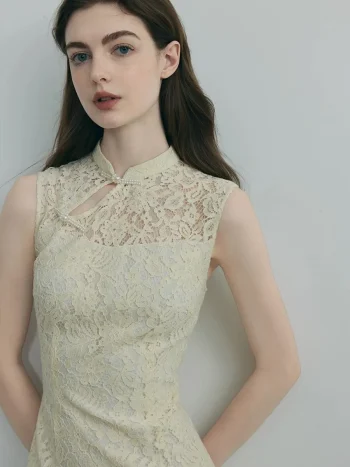 Close-up of the neckline of a white modern cheongsam dress, showing the delicate lace overlay, traditional frog closure with pearl accents, and the keyhole cutout design.