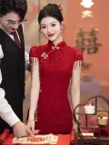 Elegant wine red chinese wedding cheongsam dress with delicate floral lace pattern, form-fitting midi cheongsam with traditional mandarin collar, perfect for modern chinese weddings.