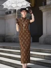 Women's Old Shanghai checkered printed long cheongsam, a classic Shanghai qipao dress, showcased outdoors on stone steps. The model holds a white lace parasol, wearing a vintage-inspired checkered qipao with short sleeves, a high stand-up collar, and elegant high slit design, styled with period accessories like a net hat and long pearl necklace.