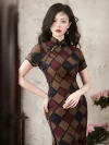 Women's retro checkered short sleeve cheongsam, a classic Old Shanghai style qipao, features a vintage geometric plaid pattern in warm brown, burgundy, and navy tones. The elegant stand-up collar with traditional frog buttons and tailored fit are highlighted as the model poses indoors.