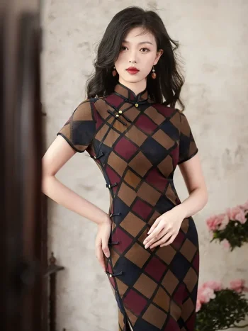 Women's retro checkered short sleeve cheongsam, a classic Old Shanghai style qipao, features a vintage geometric plaid pattern in warm brown, burgundy, and navy tones. The elegant stand-up collar with traditional frog buttons and tailored fit are highlighted as the model poses indoors.