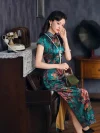 Model wearing vintage green printed silk long qipao seated on piano in retro room, elegant traditional Chinese dress with peony print