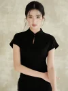 Close up of the stand collar on a black slim fit qipao dress worn by a woman. The women qipao features a small keyhole cutout and a single button detail for a refined look.