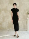 A woman wearing a black slim fit qipao dress stands facing the camera. This elegant women qipao features a classic stand collar with a keyhole cutout, side drawstring detail, and a flowing silhouette.