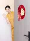 Yellow Modern Cheongsam Wedding Dress - Bride in chinese cheongsam waving from behind door with red double happiness decoration, brocade qipao with pearl tassel buttons for wedding photoshoots