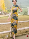 Model standing in a women high end yellow mulberry silk cheongsam dress with landscape print, with highlighted tailored fit showing the figure-flattering design.