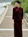 Elegant asian female model stands beside river and lush green bushes in waist pleated Velvet Long Sleeve Burgundy Cheongsam with classic diagonal placket, luxury soft Cheongsam Velvet long sleeve formal cheongsam for wedding guest wear