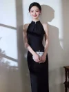 Beautiful portrait of a model wearing a classy black qipao dress, holding a sparkling pearl clutch bag and smiling in natural window sunlight.